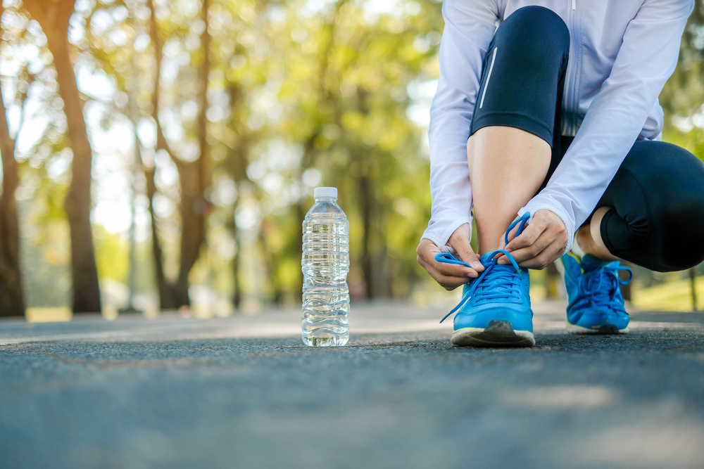 Woman lacing up trainers