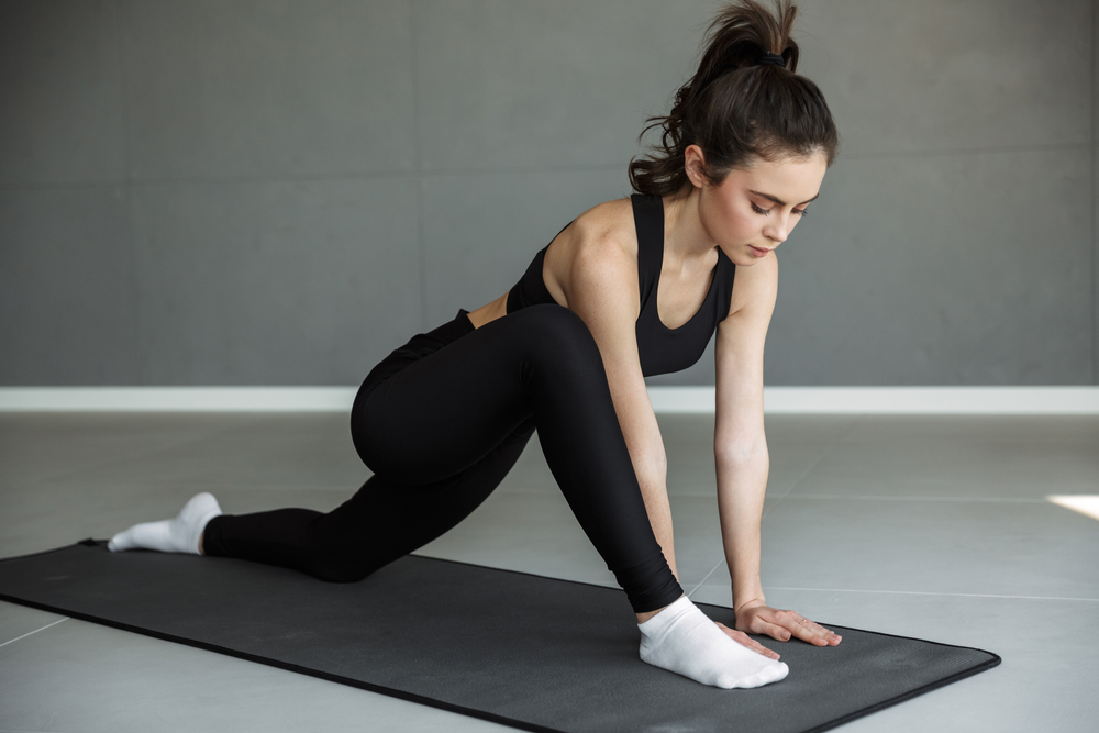 Woman stretching avoid gym injuries