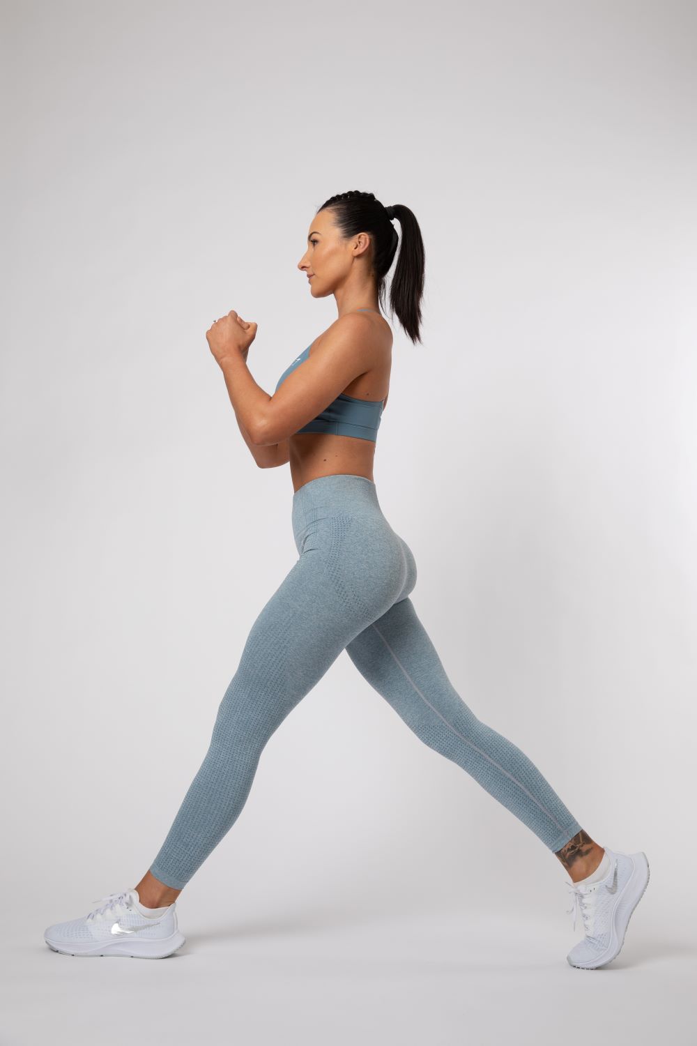woman doing a lunge personal trainer home workout 