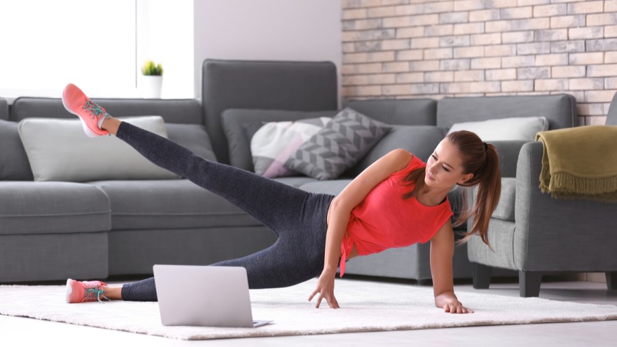 woman following a personal trainer home workout plan