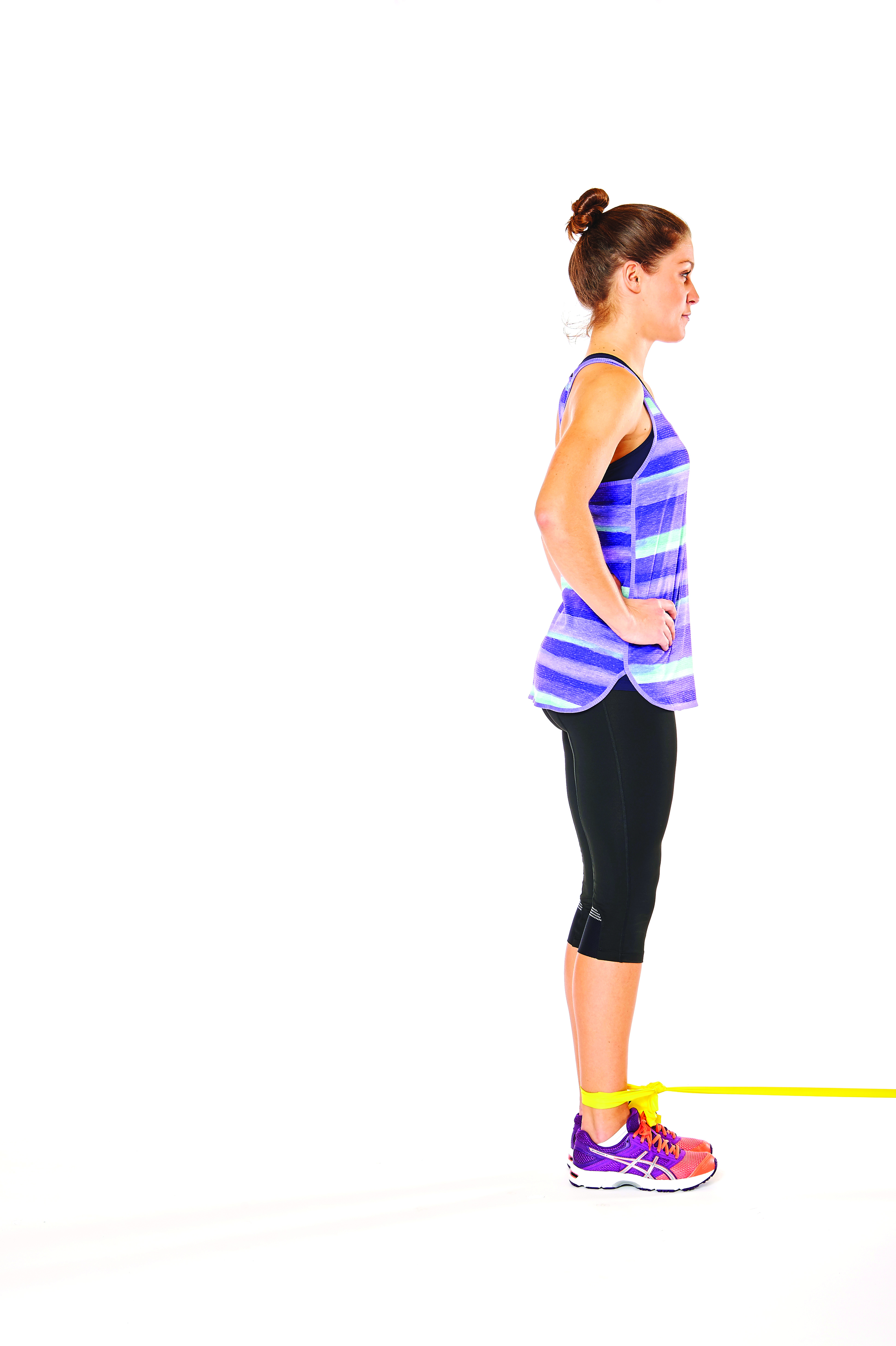 woman demonstrating glute lifts in 15 minute resistance band workout