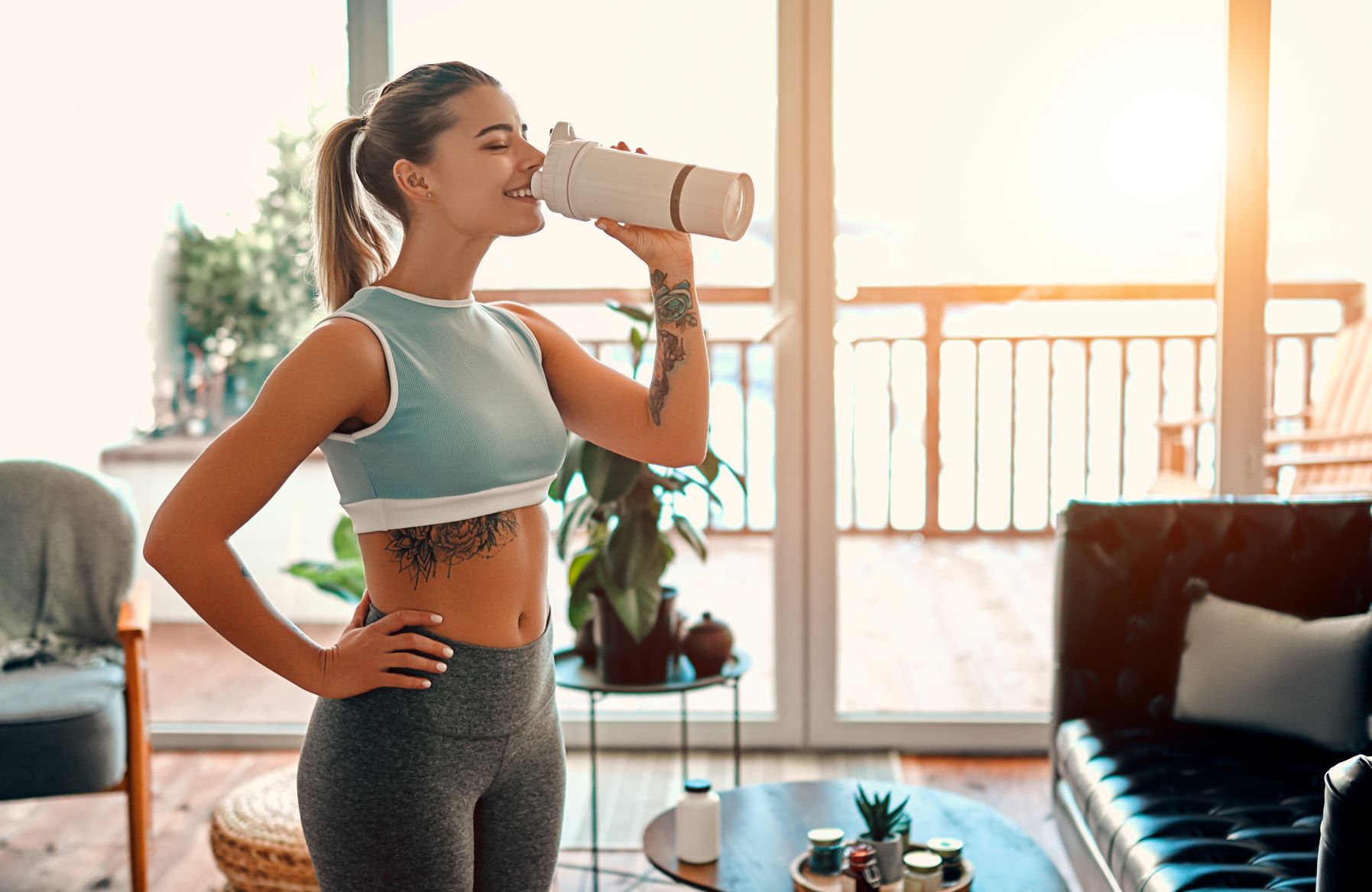 woman drinking protein shake during post workout recovery