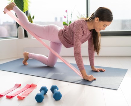 woman using resistance band for glute workout
