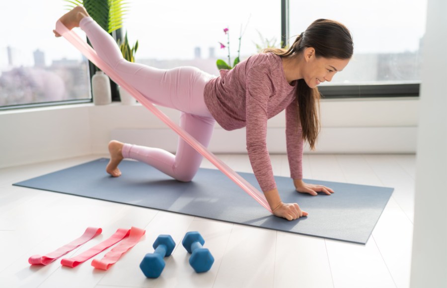 woman using resistance band for glute workout