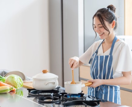 woman cooking healthy food in kitchen
