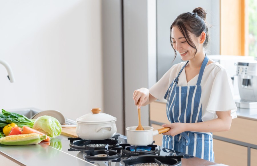 woman cooking healthy food in kitchen