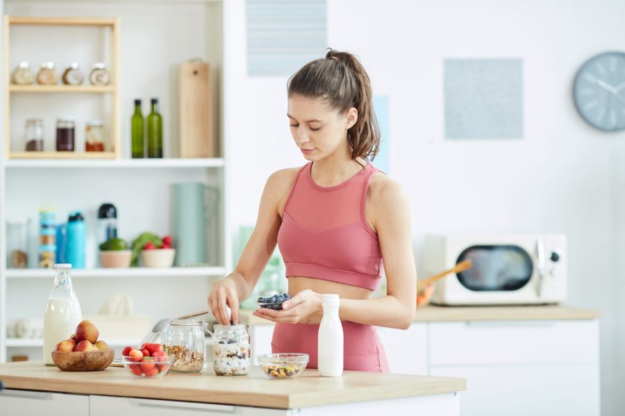 woman preparing healthy breakfast recipes overnight oats
