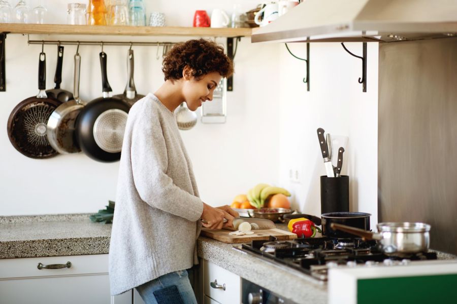 woman cutting vegetables making healthy lunch