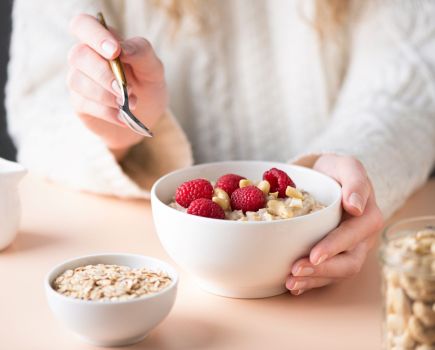 woman eating porridge best fat burning foods to boost metabolism