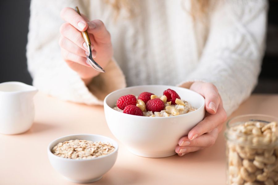 woman eating porridge best fat burning foods to boost metabolism
