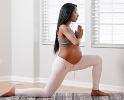 pregnant woman doing yoga wearing maternity activewear