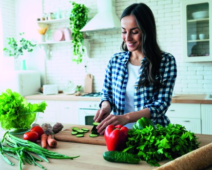 healthy eating habits woman cooking vegetables