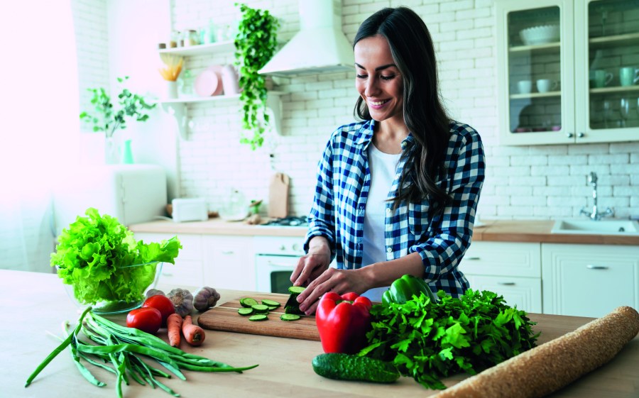 healthy eating habits woman cooking vegetables