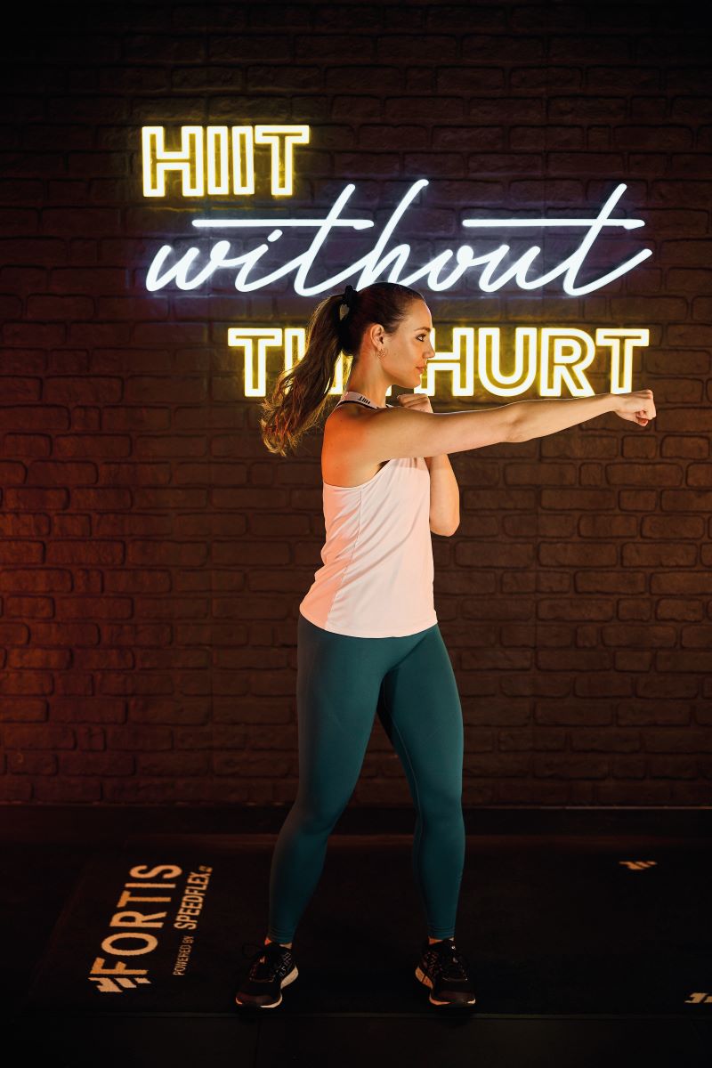 woman demonstrating cross body punches 