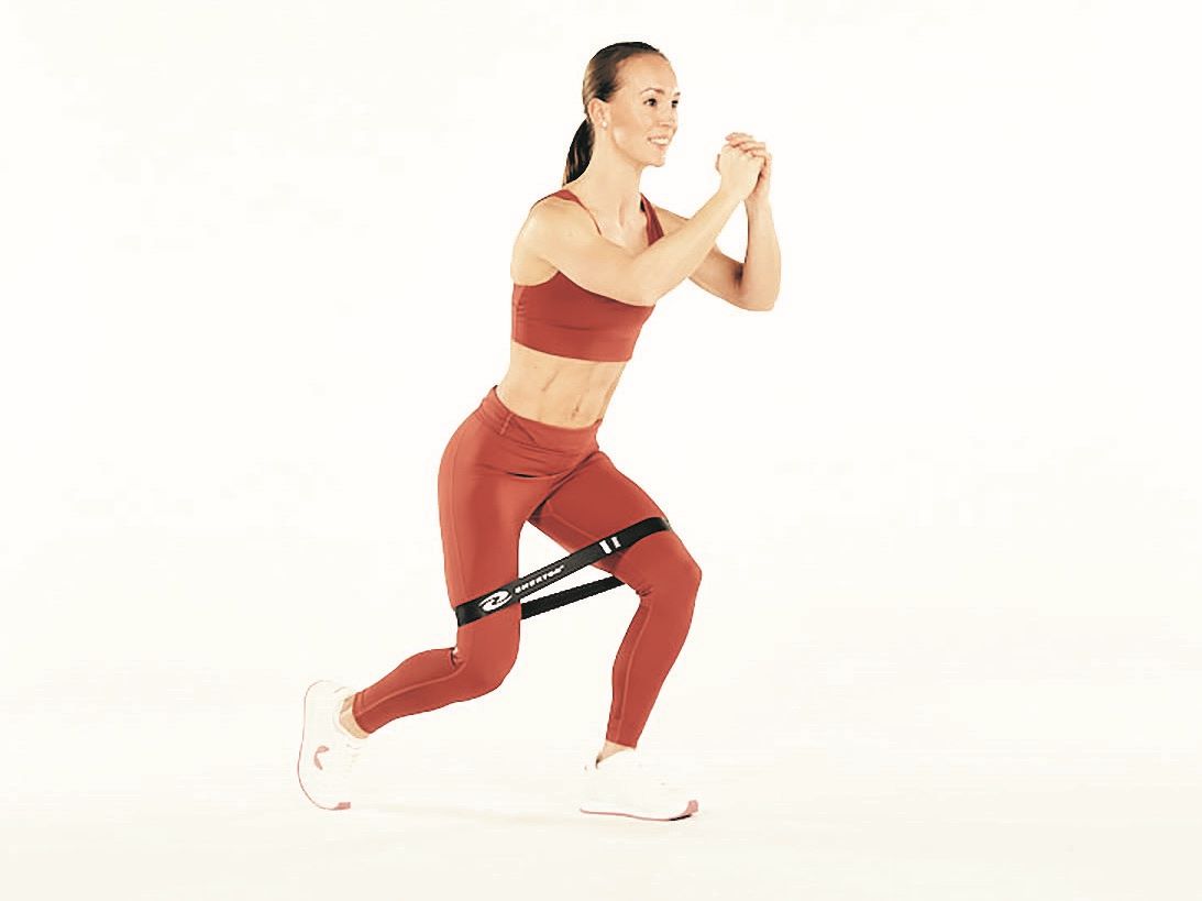 woman demonstrated two way touches in resistance band workout for runners