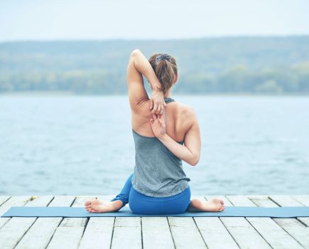 woman practicing yoga poses to stretch and strengthen back