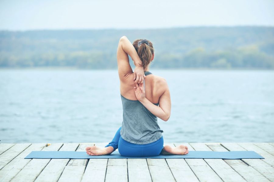 woman practicing yoga poses to stretch and strengthen back