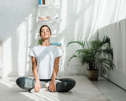 woman doing energising yoga flow in the morning