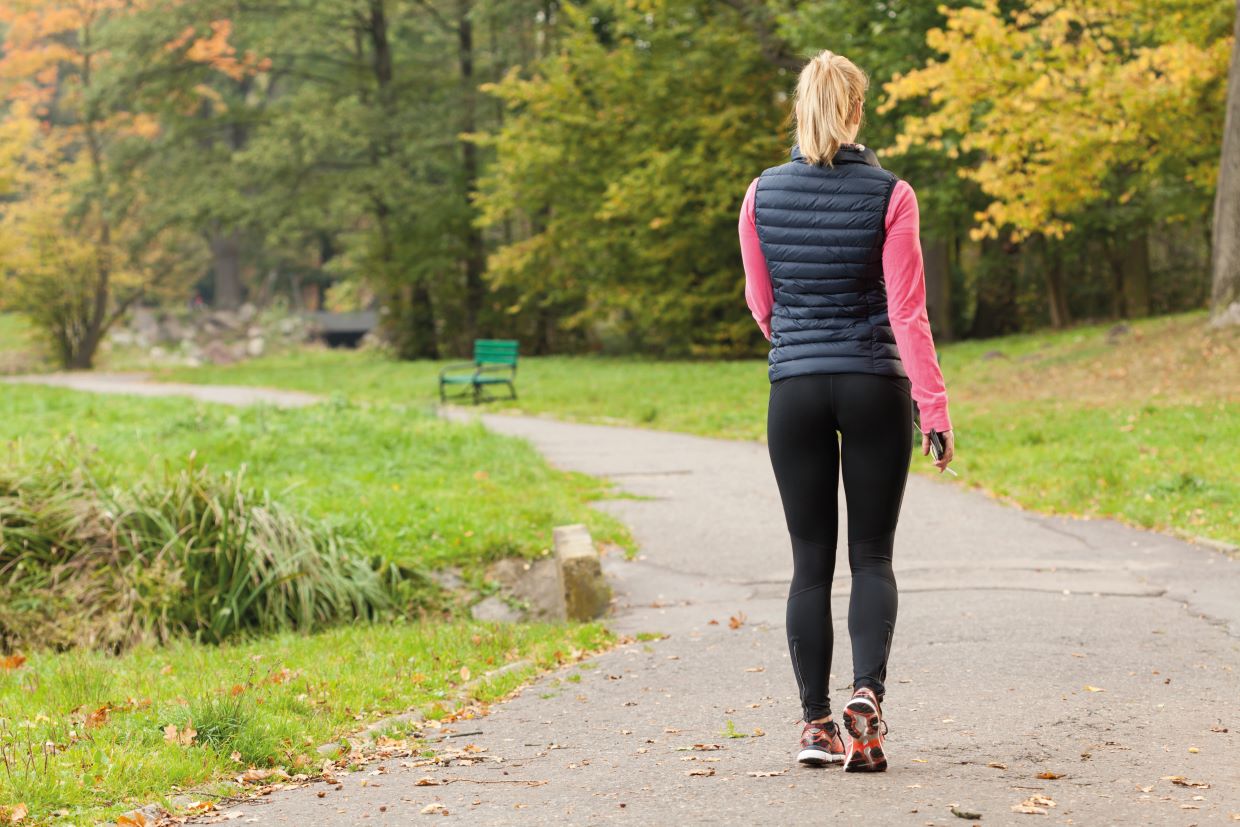 walking woman in park winter