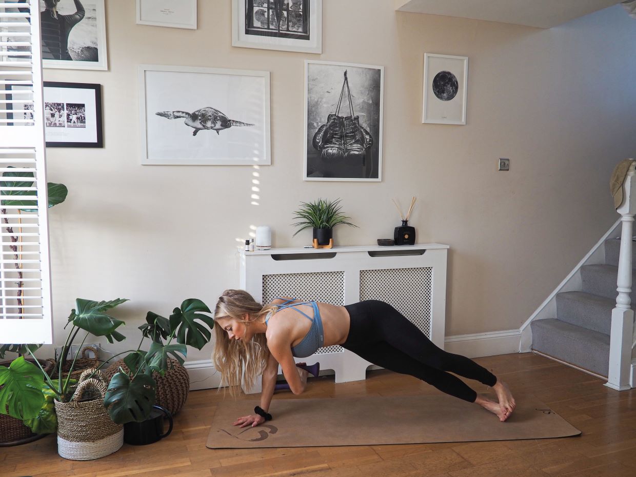 woman demonstrating thread the needle exercise in 10 minute home workout for busy schedules