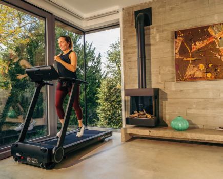 woman using echelon stride treadmill at home