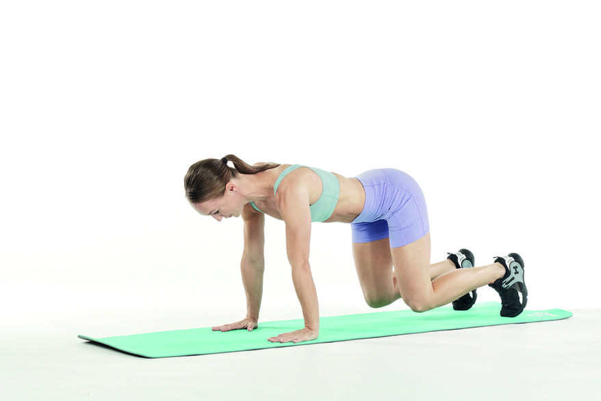 woman demonstrates bear crawls