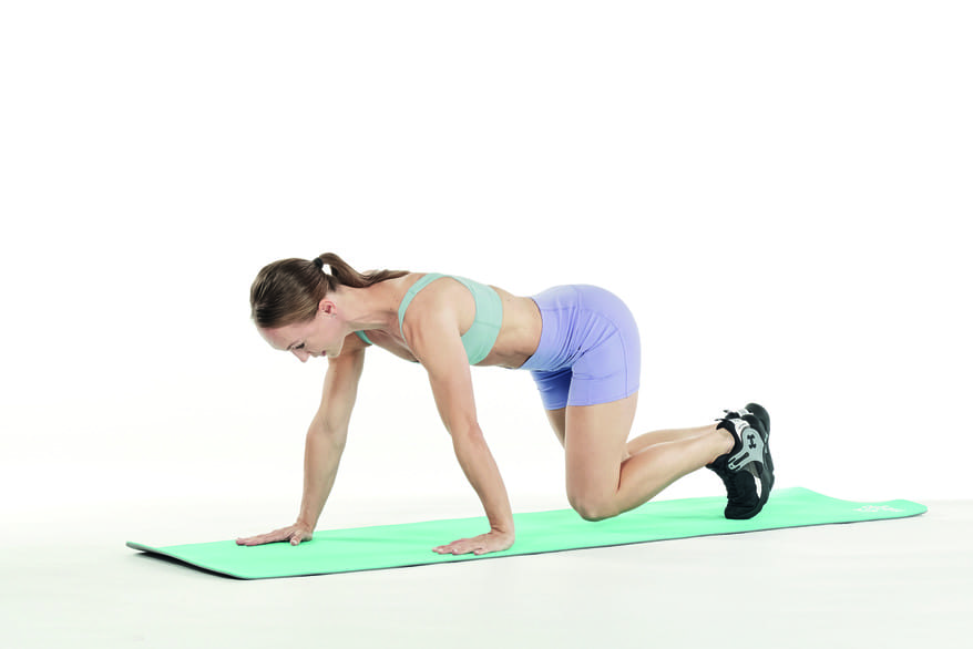 woman demonstrates how to do bear crawls