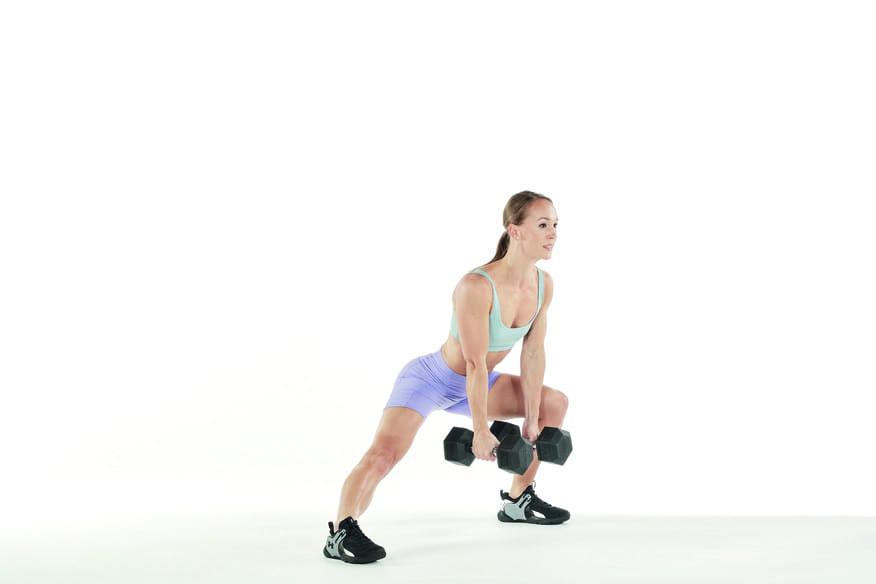 woman holds dumbbells demonstrates lateral lunges in full body 10 minute workout