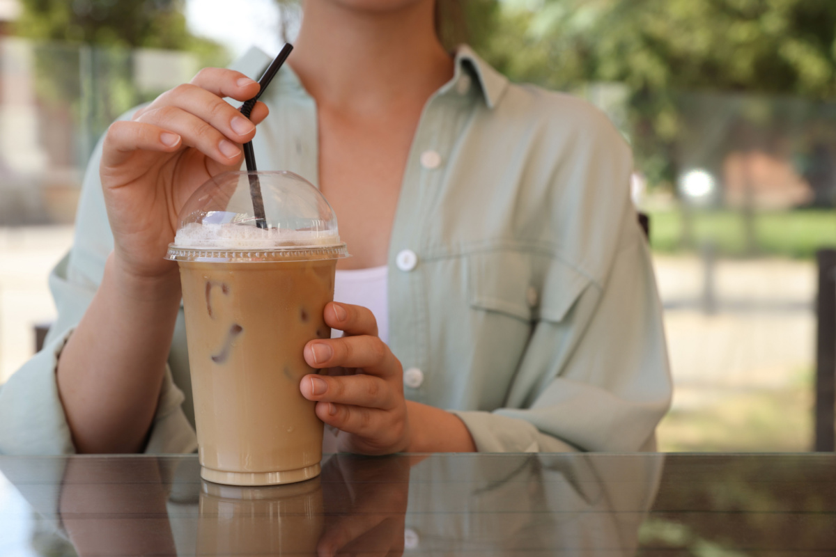 woman drinking iced coffee