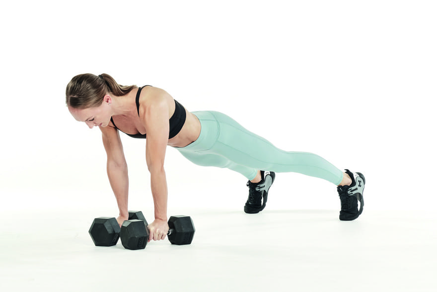 woman performs alternating renegade row with dumbbells in strength workout for runners