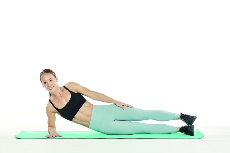 woman demonstrates side plank in strength workout for runners 