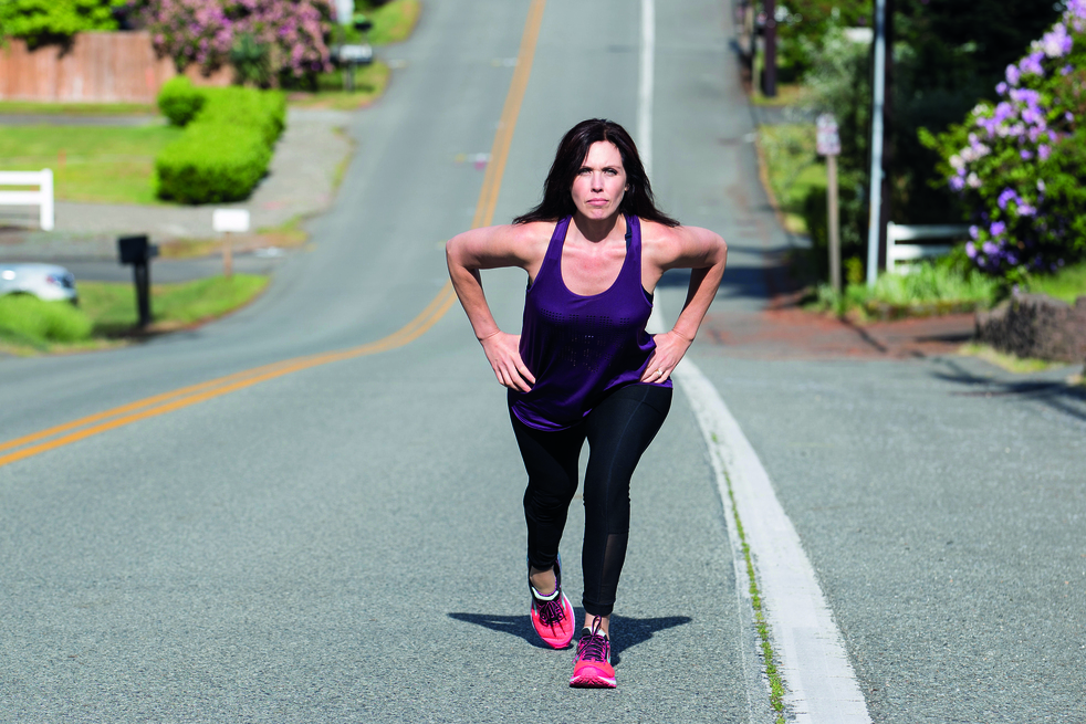 woman speed hiking up hill