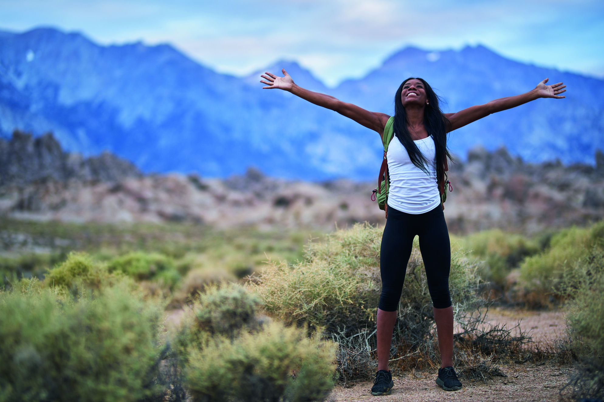 woman hiking in mountains happy