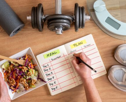 woman writing diet plan for healthy weight loss