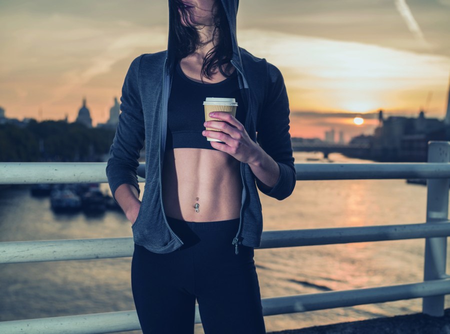 woman holding coffee before workout