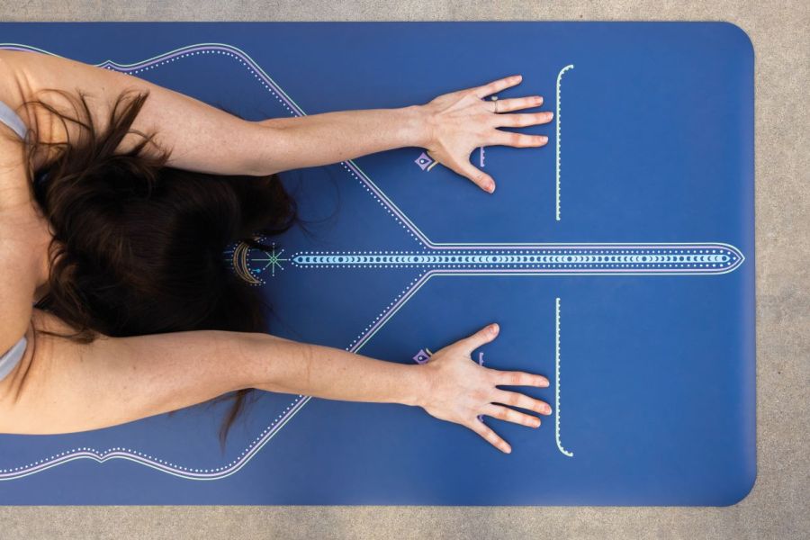 woman stretching on liforme mat