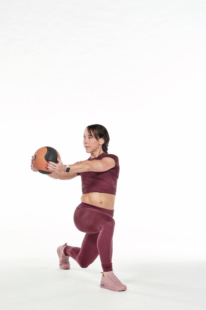 woman demonstrates twisted lunge best exercises with medicine ball