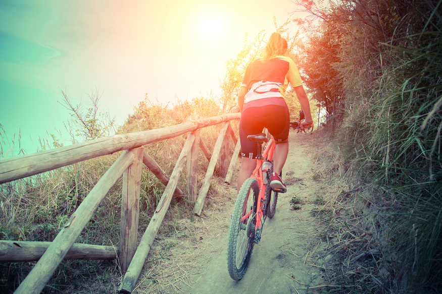 woman cycling uphill outdoors