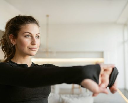 woman stretching and concentrating before workout