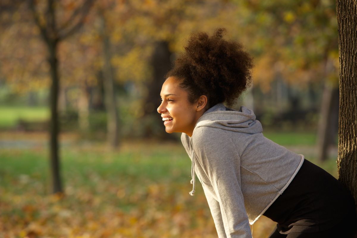 woman feeling mindful and happy while running
