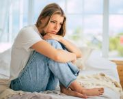 woman on bed sad and waiting