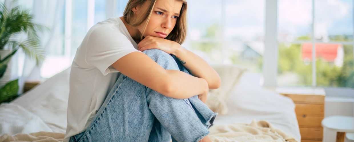 woman on bed sad and waiting