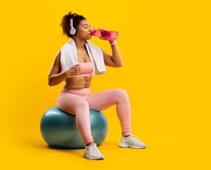 woman hydrating after exercise