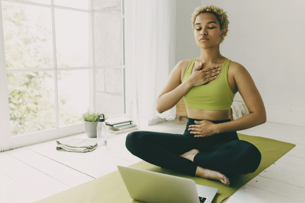 woman with hands on belly and chest practising full yogic breath