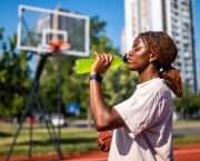 woman drinking sports drink outside
