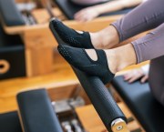 woman wearing grippy socks for reformer pilates class,
