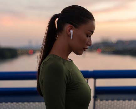 woman wearing wireless earbuds running