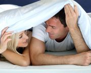 Couple in bed under the blanket