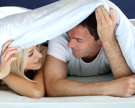 Couple in bed under the blanket