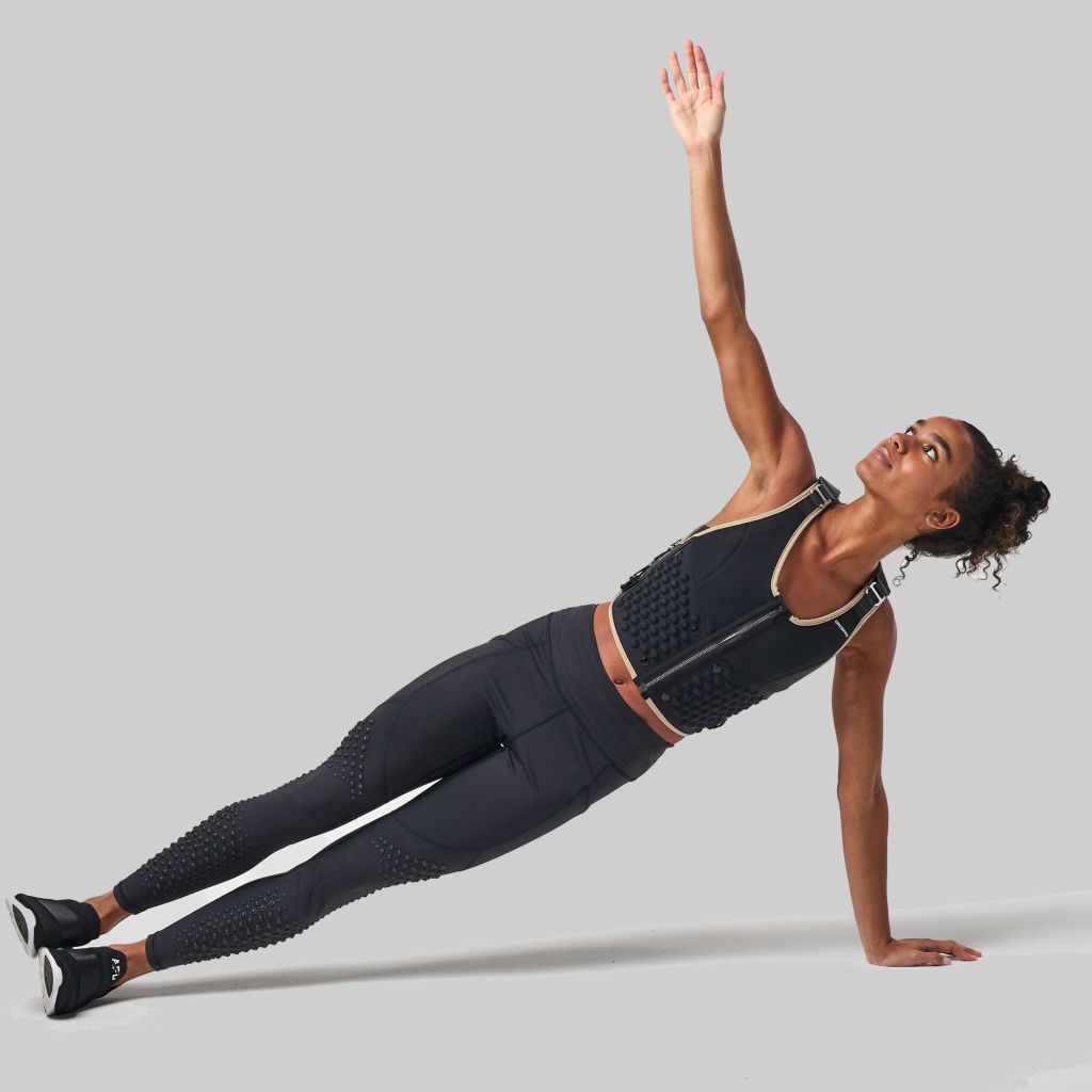 woman performing side plank exercise while wearing OMORPHO G-Vest Icon
